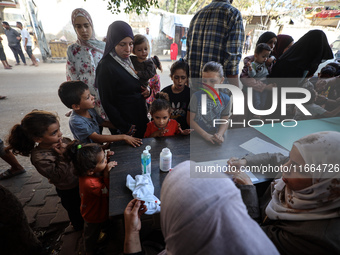 Palestinian children receive drops as part of a polio vaccination campaign in Deir al-Balah, Gaza Strip, on October 14, 2024, amid the ongoi...