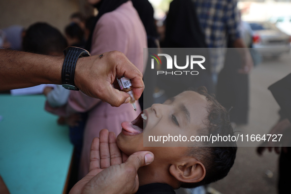 Palestinian children receive drops as part of a polio vaccination campaign in Deir al-Balah, Gaza Strip, on October 14, 2024, amid the ongoi...