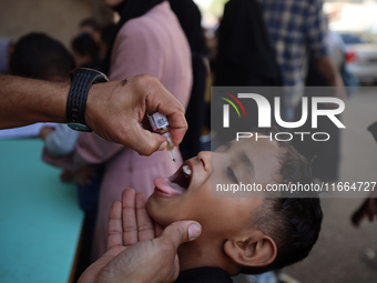 Palestinian children receive drops as part of a polio vaccination campaign in Deir al-Balah, Gaza Strip, on October 14, 2024, amid the ongoi...