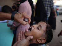 Palestinian children receive drops as part of a polio vaccination campaign in Deir al-Balah, Gaza Strip, on October 14, 2024, amid the ongoi...