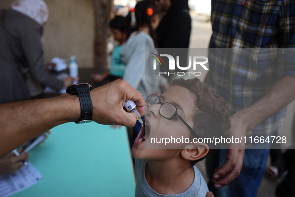 Palestinian children receive drops as part of a polio vaccination campaign in Deir al-Balah, Gaza Strip, on October 14, 2024, amid the ongoi...