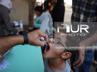 Palestinian children receive drops as part of a polio vaccination campaign in Deir al-Balah, Gaza Strip, on October 14, 2024, amid the ongoi...