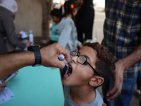 Palestinian children receive drops as part of a polio vaccination campaign in Deir al-Balah, Gaza Strip, on October 14, 2024, amid the ongoi...