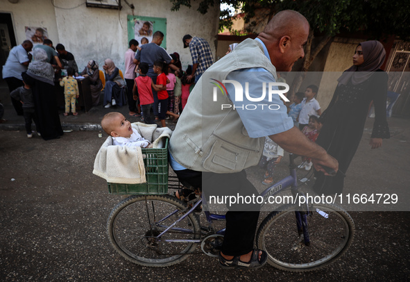 Palestinian children receive drops as part of a polio vaccination campaign in Deir al-Balah, Gaza Strip, on October 14, 2024, amid the ongoi...