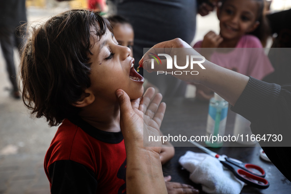 Palestinian children receive drops as part of a polio vaccination campaign in Deir al-Balah, Gaza Strip, on October 14, 2024, amid the ongoi...