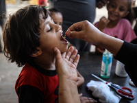 Palestinian children receive drops as part of a polio vaccination campaign in Deir al-Balah, Gaza Strip, on October 14, 2024, amid the ongoi...