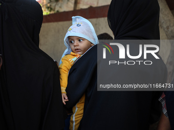 Palestinian children receive drops as part of a polio vaccination campaign in Deir al-Balah, Gaza Strip, on October 14, 2024, amid the ongoi...