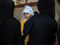 Palestinian children receive drops as part of a polio vaccination campaign in Deir al-Balah, Gaza Strip, on October 14, 2024, amid the ongoi...