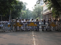 Police officers block a road in front of the Governor's house while doctors and citizens shout slogans during a protest march demanding that...