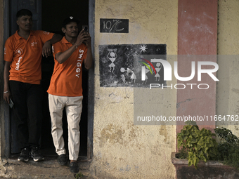 A Swiggy delivery person takes a mobile photograph at an event in Mumbai, India, on October 14, 2024. IPO-bound Swiggy launches an XL fleet...