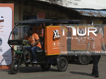 Swiggy gig workers ride electric three-wheelers during a promotional event in Mumbai, India, on October 14, 2024. IPO-bound Swiggy launches...