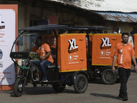 Swiggy gig workers ride electric three-wheelers during a promotional event in Mumbai, India, on October 14, 2024. IPO-bound Swiggy launches...