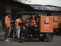 Swiggy gig workers ride electric three-wheelers during a promotional event in Mumbai, India, on October 14, 2024. IPO-bound Swiggy launches...