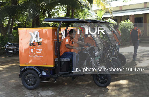 Swiggy gig workers ride electric three-wheelers during a promotional event in Mumbai, India, on October 14, 2024. IPO-bound Swiggy launches...