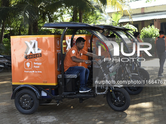 Swiggy gig workers ride electric three-wheelers during a promotional event in Mumbai, India, on October 14, 2024. IPO-bound Swiggy launches...