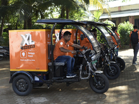 Swiggy gig workers ride electric three-wheelers during a promotional event in Mumbai, India, on October 14, 2024. IPO-bound Swiggy launches...