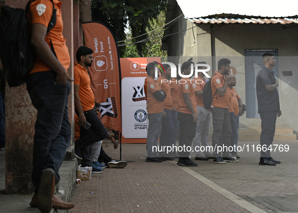 Swiggy gig workers stand during a promotional event in Mumbai, India, on October 14, 2024. IPO-bound Swiggy launches an XL fleet to cater to...