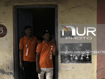 A Swiggy delivery person takes a mobile photograph at an event in Mumbai, India, on October 14, 2024. IPO-bound Swiggy launches an XL fleet...