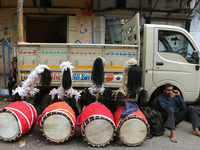 Traditional Bengali drum players, known as Dhaki, gather on a footpath in North Kolkata, India, on October 14, 2024, as temporary shelters w...