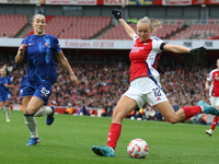 Chelsea's Lucy Bronze runs to stop Arsenal's Frida Maanum from putting the ball in during the Barclays FA Women's Super League match between...