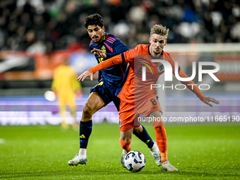 Sweden player Ahmed Qasem and Netherlands player Kenneth Taylor participate in the match between Netherlands U21 and Sweden U21 at the Goffe...