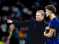 Netherlands trainer Ronald Koeman and Netherlands midfielder Mats Wieffer participate during the match between Germany and the Netherlands a...