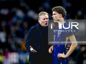 Netherlands trainer Ronald Koeman and Netherlands midfielder Mats Wieffer participate during the match between Germany and the Netherlands a...