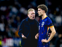 Netherlands trainer Ronald Koeman and Netherlands midfielder Mats Wieffer participate during the match between Germany and the Netherlands a...