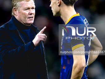 Netherlands trainer Ronald Koeman and Netherlands midfielder Mats Wieffer participate during the match between Germany and the Netherlands a...