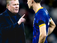 Netherlands trainer Ronald Koeman and Netherlands midfielder Mats Wieffer participate during the match between Germany and the Netherlands a...