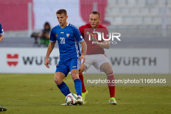 In Ta' Qali, Malta, on October 13, 2024, Sergiu Platica of Moldova is closely followed by Ryan Camenzuli of Malta during the UEFA Nations Le...