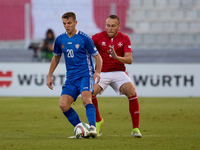 In Ta' Qali, Malta, on October 13, 2024, Sergiu Platica of Moldova is closely followed by Ryan Camenzuli of Malta during the UEFA Nations Le...