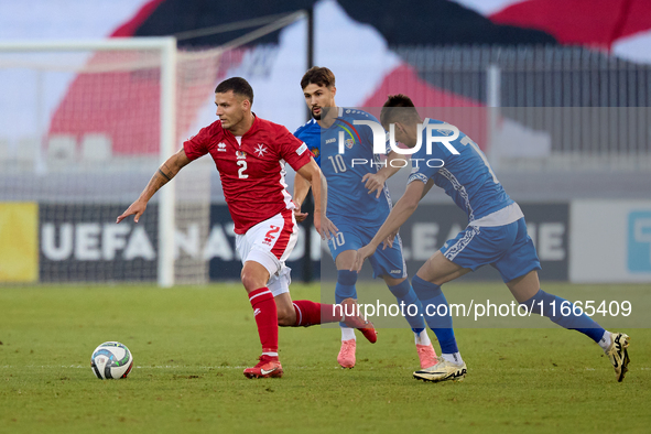 In Ta' Qali, Malta, on October 13, 2024, Jean Borg of Malta moves away from Vitalie Damascan and Mihail Caimacov of Moldova during the UEFA...