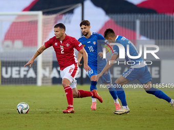 In Ta' Qali, Malta, on October 13, 2024, Jean Borg of Malta moves away from Vitalie Damascan and Mihail Caimacov of Moldova during the UEFA...