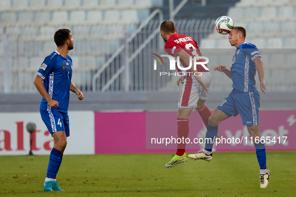 In Ta' Qali, Malta, on October 13, 2024, Sergiu Platica of Moldova heads the ball during the UEFA Nations League, League D, Group D2 soccer...