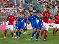 In Ta' Qali, Malta, on October 13, 2024, Luke Montebello of Malta is closely challenged by Vladislav Babogio of Moldova during the UEFA Nati...