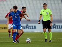 Victor Mudrac of Moldova vies for the ball with Luke Montebello of Malta during the UEFA Nations League, League D, Group D2 soccer match bet...