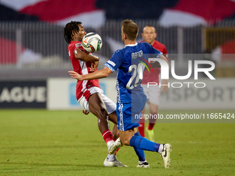 In Ta' Qali, Malta, on October 13, 2024, Paul Mbong of Malta competes for the ball with Sergiu Platica of Moldova during the UEFA Nations Le...