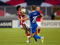 In Ta' Qali, Malta, on October 13, 2024, Paul Mbong of Malta competes for the ball with Sergiu Platica of Moldova during the UEFA Nations Le...