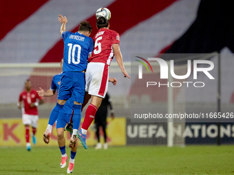 In Ta' Qali, Malta, on October 13, 2024, Vitalie Damascan of Moldova vies for the ball with Kurt Shaw of Malta during the UEFA Nations Leagu...