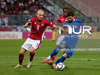 In Ta' Qali, Malta, on October 13, 2024, Gabriel Mentz of Malta vies for the ball with Vitalie Damascan of Moldova during the UEFA Nations L...