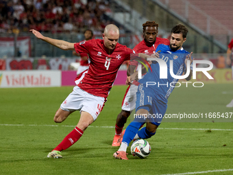 In Ta' Qali, Malta, on October 13, 2024, Gabriel Mentz of Malta vies for the ball with Vitalie Damascan of Moldova during the UEFA Nations L...