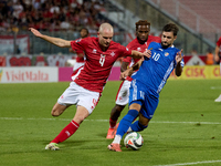 In Ta' Qali, Malta, on October 13, 2024, Gabriel Mentz of Malta vies for the ball with Vitalie Damascan of Moldova during the UEFA Nations L...