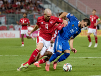 In Ta' Qali, Malta, on October 13, 2024, Gabriel Mentz of Malta vies for the ball with Vitalie Damascan of Moldova during the UEFA Nations L...