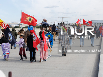 Members of the Muwekma Ohlone Tribe of the San Francisco Bay Area, along with other tribal groups and their supporters, cross the Arlington...