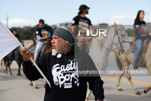 Members of the Muwekma Ohlone Tribe of the San Francisco Bay Area, along with other tribal groups and their supporters, cross the Arlington...