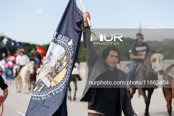 Members of the Muwekma Ohlone Tribe of the San Francisco Bay Area, along with other tribal groups and their supporters, cross the Arlington...