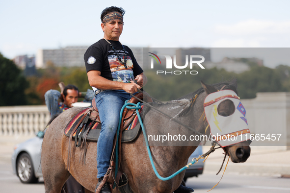 Members of the Muwekma Ohlone Tribe of the San Francisco Bay Area, along with other tribal groups and their supporters, cross the Arlington...