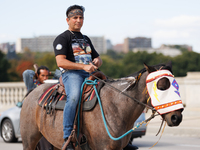 Members of the Muwekma Ohlone Tribe of the San Francisco Bay Area, along with other tribal groups and their supporters, cross the Arlington...