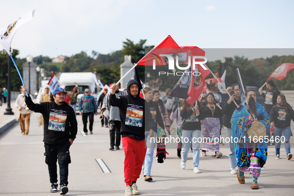 Members of the Muwekma Ohlone Tribe of the San Francisco Bay Area, along with other tribal groups and their supporters, cross the Arlington...